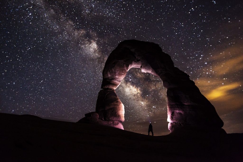 Lindo arco de pedras iluminado e ao fundo o cosmos. A Filosofia e a Astronomia: instâncias em que o Thauma aparece